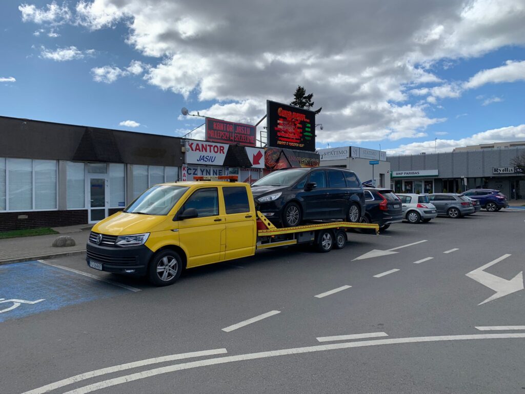 Laweta Magdeburg transportująca samochód w mieście, oferująca szybkie i niezawodne usługi holownicze dla kierowców.